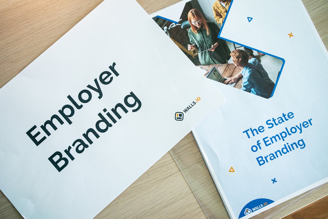 heros-img Flat lay of employer branding materials on an office table, showcasing marketing and design.